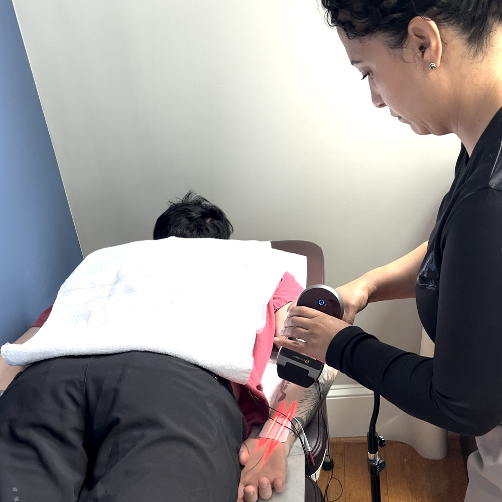 Cold laser therapy being provided at CorAxis Chiropractic & Wellness.