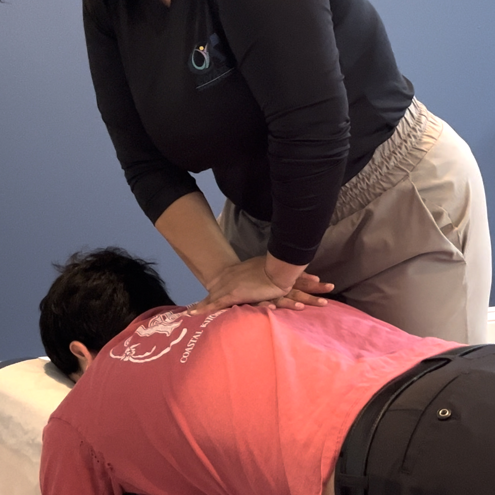 Manual chiropractic adjustment at CorAxis Chiropractic & Wellness.